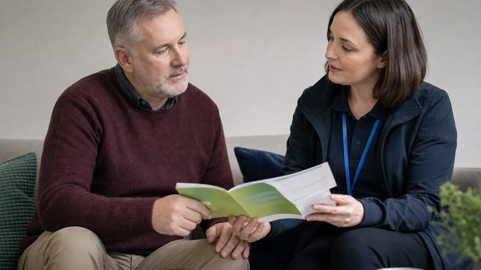 A homeowner receiving information about Warmer Homes Scotland from an advice worker