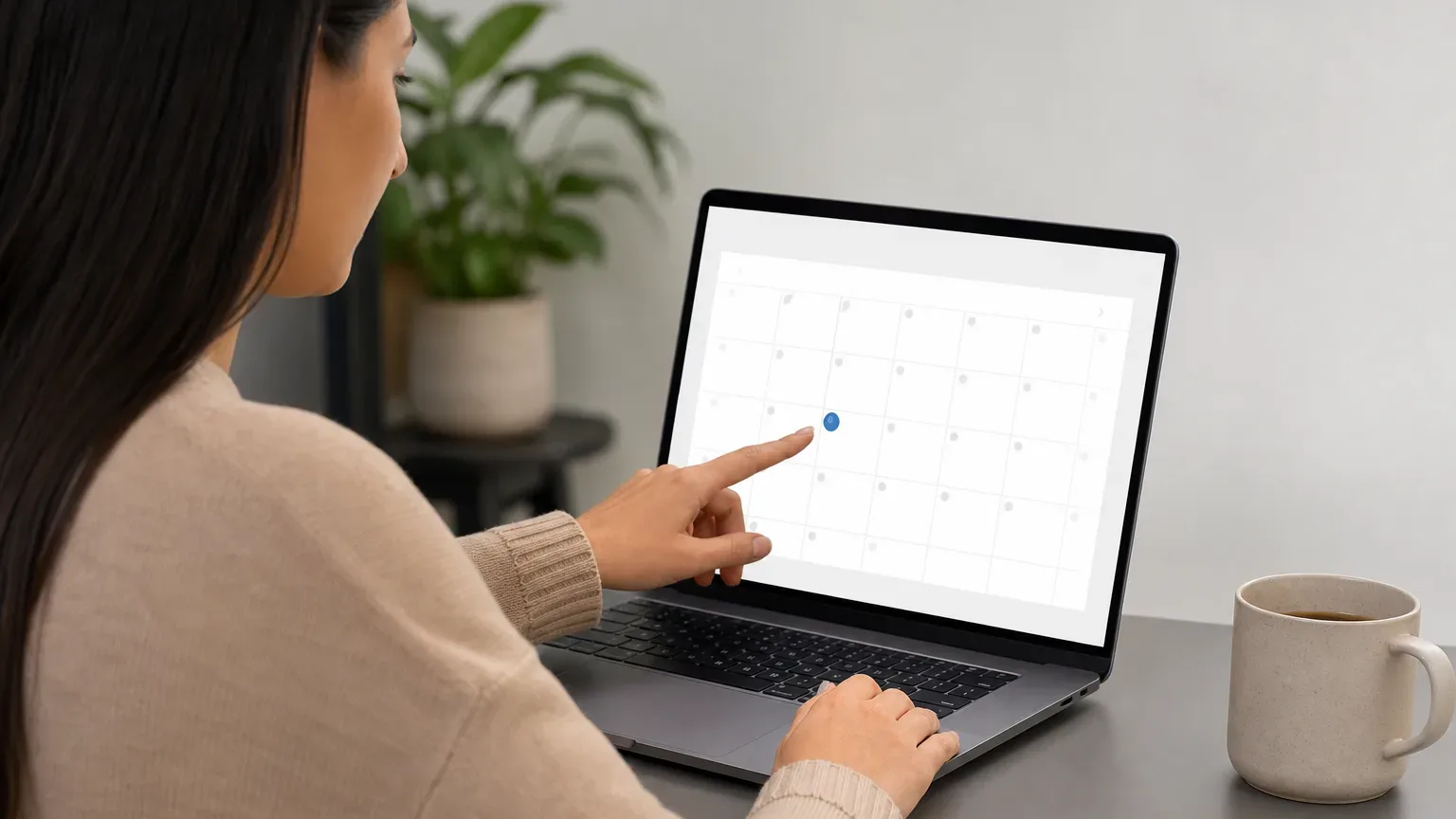 A person selecting a service appointment date on an online calendar on a laptop