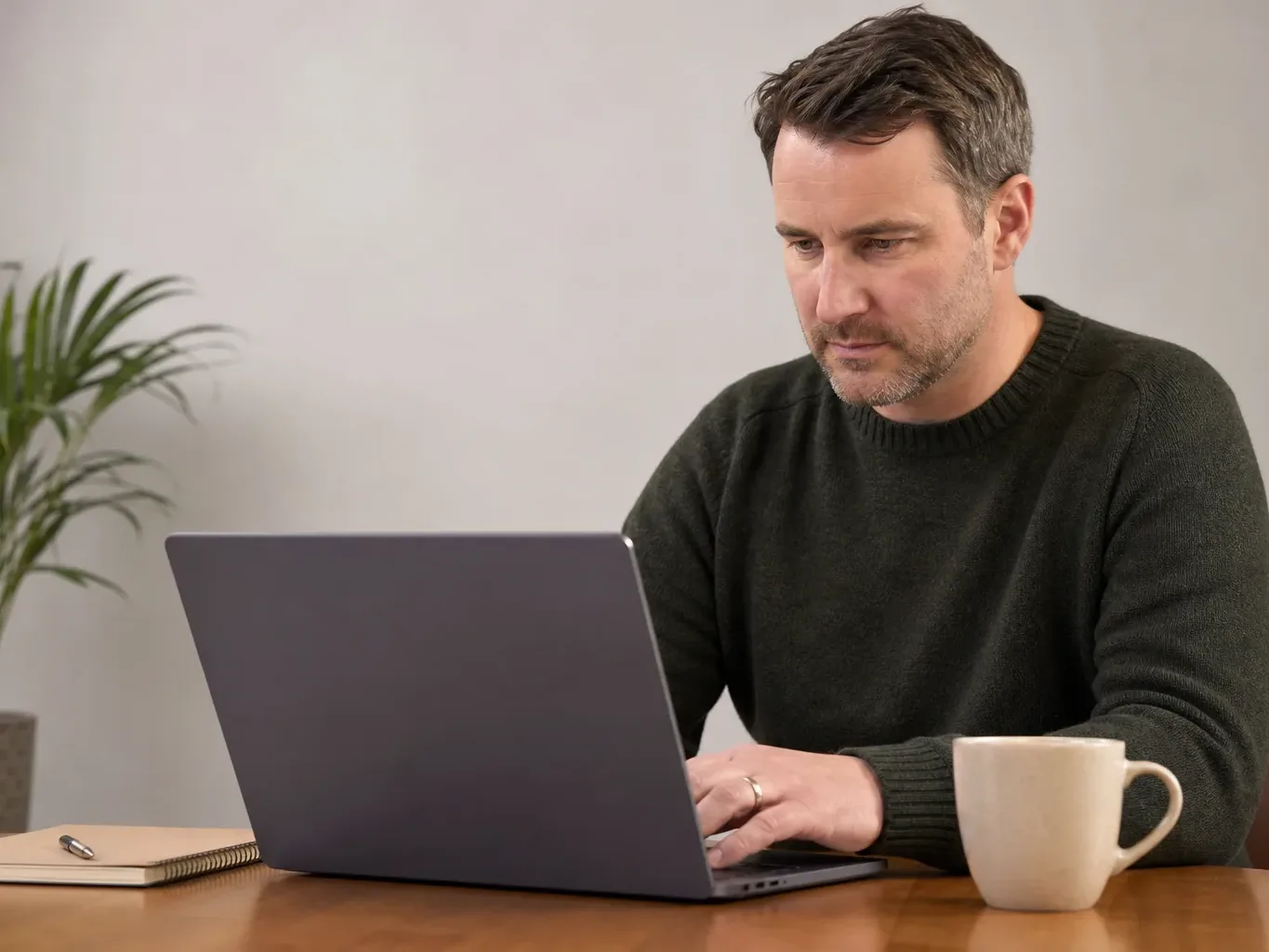 A landlord verifying an engineer's credentials on a Gas Safe register webpage on a laptop